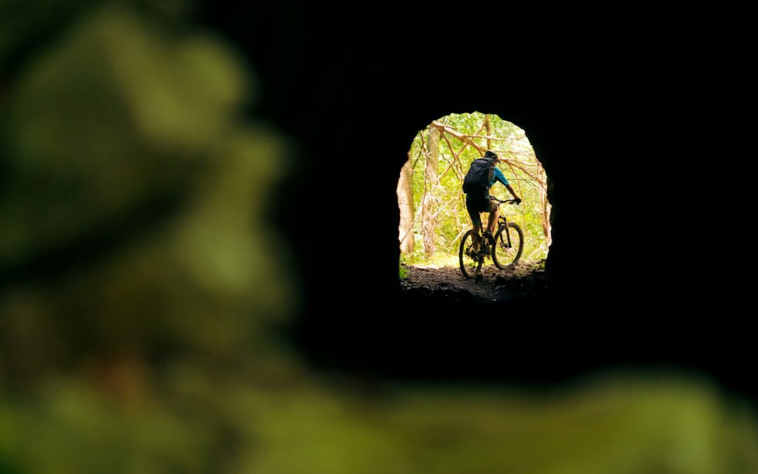 biker in mountain bike at the end of a tunnel